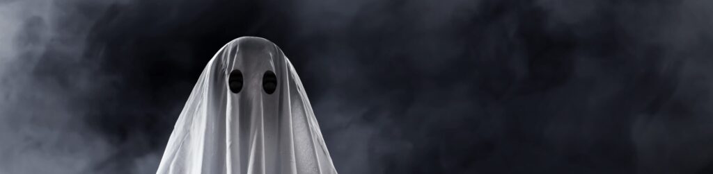 a ghost made out of a tablecloth on a black background