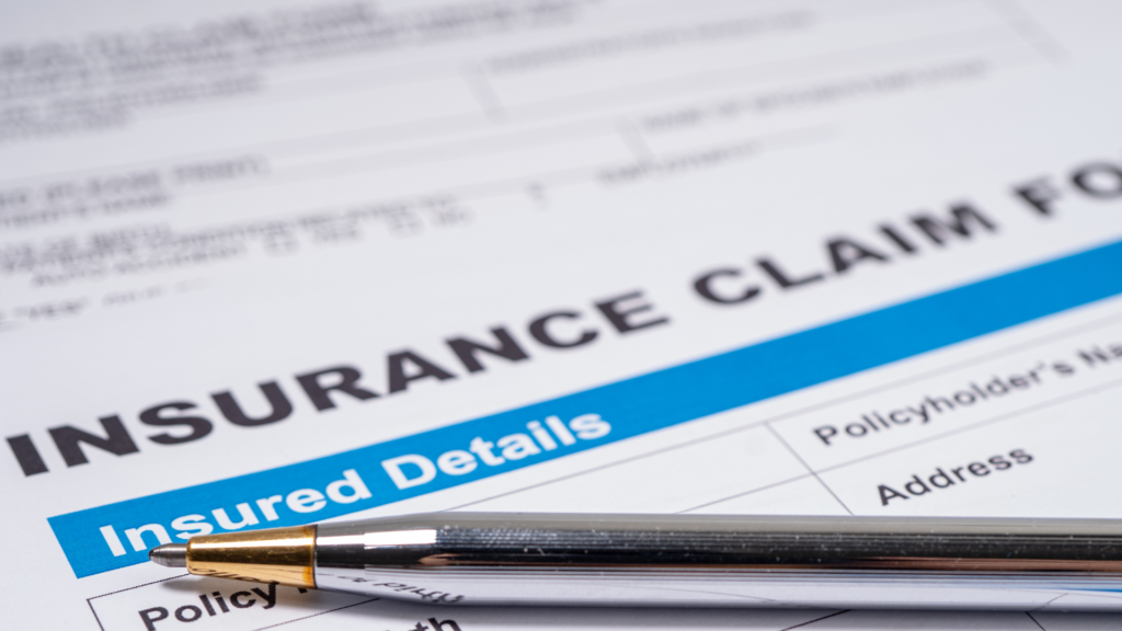 Insurance claim form with a silver pen resting on top of it