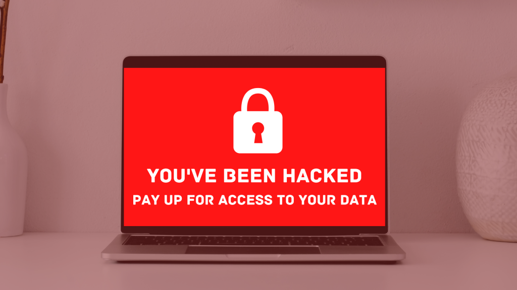computer screen with a red "you've been hacked" image with a lock on it due to a malware attack